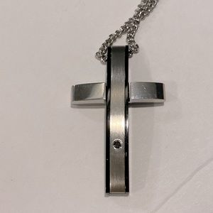 Polished stainless steel cross with black accents and diamond chip. 12” drop